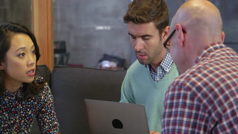 designers having meeting around table in office shot on r3d