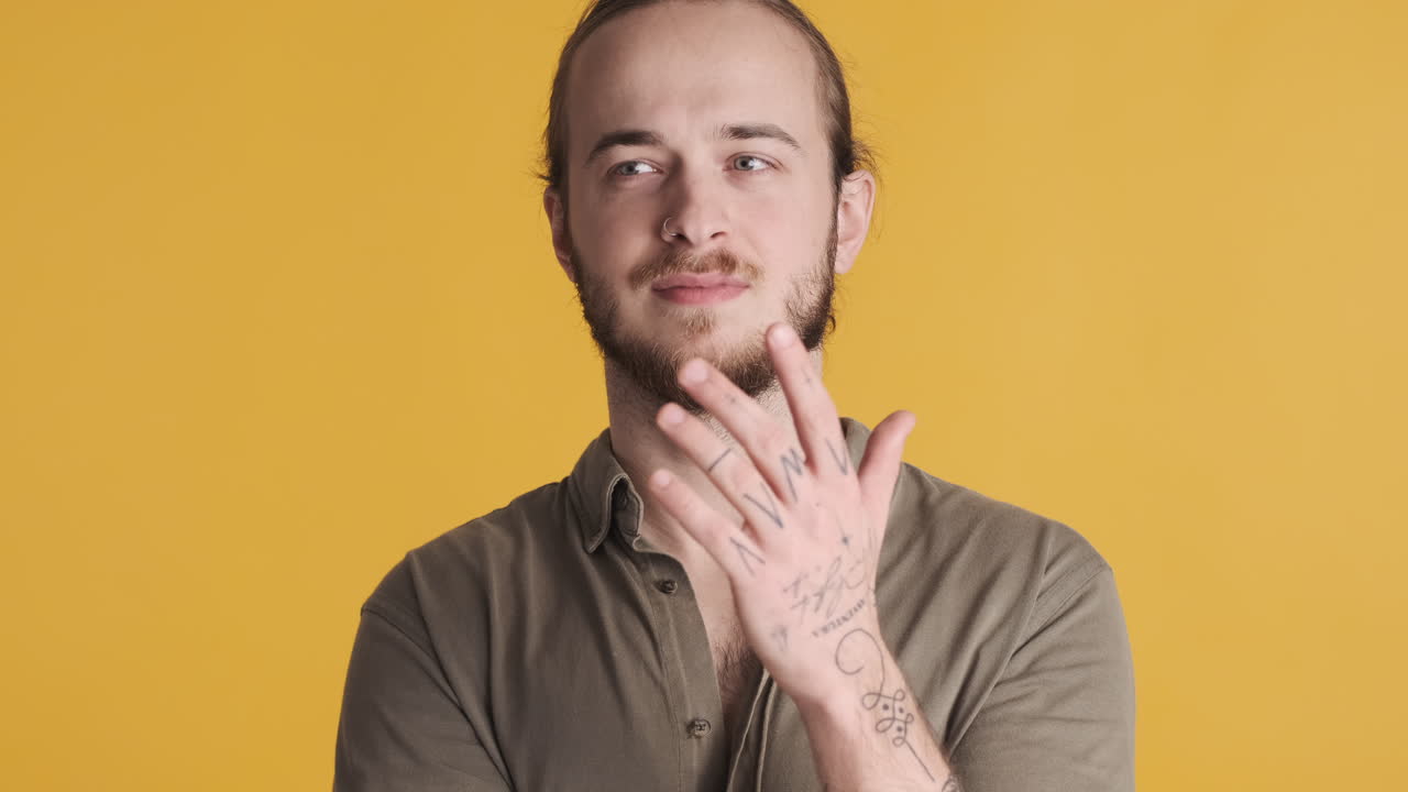 Caucasian young man pointing index finger in camera.