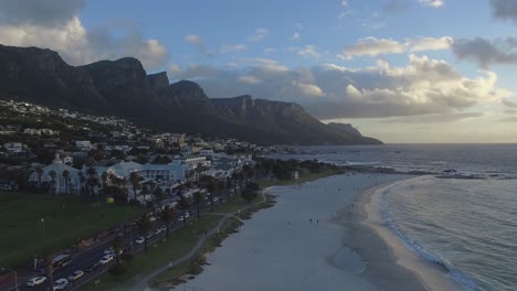 camps bay and table mountain in cape town, aerial view from the ocean during sunset