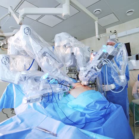 Doctors using surgical robot in hospital. Minimally invasive surgery with robotic technology equipment. Team of doctors and futuristic machine in operating room.