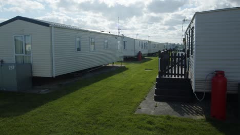 outside shot of static caravans in a caravan park with sun going behind the clouds