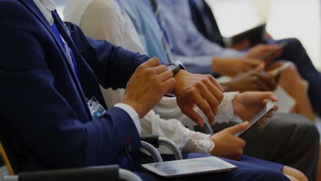 businessman using smartwatch in the business seminar 4k