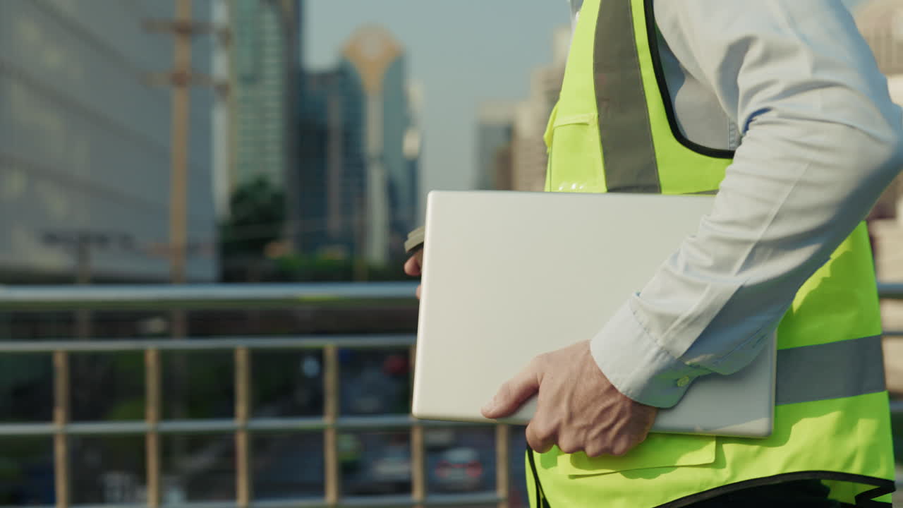 Engineer with laptop and coffee in the city