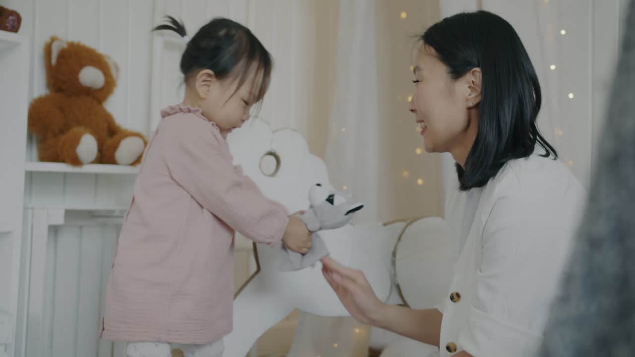 Mother and Toddler Playing with a Puppet