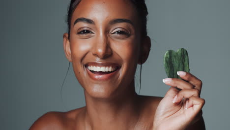 woman with gua sha for skincare