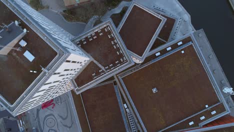 aerial top down view of moderna skyscraper office buildings. drone shot flying over rooftop high rise building