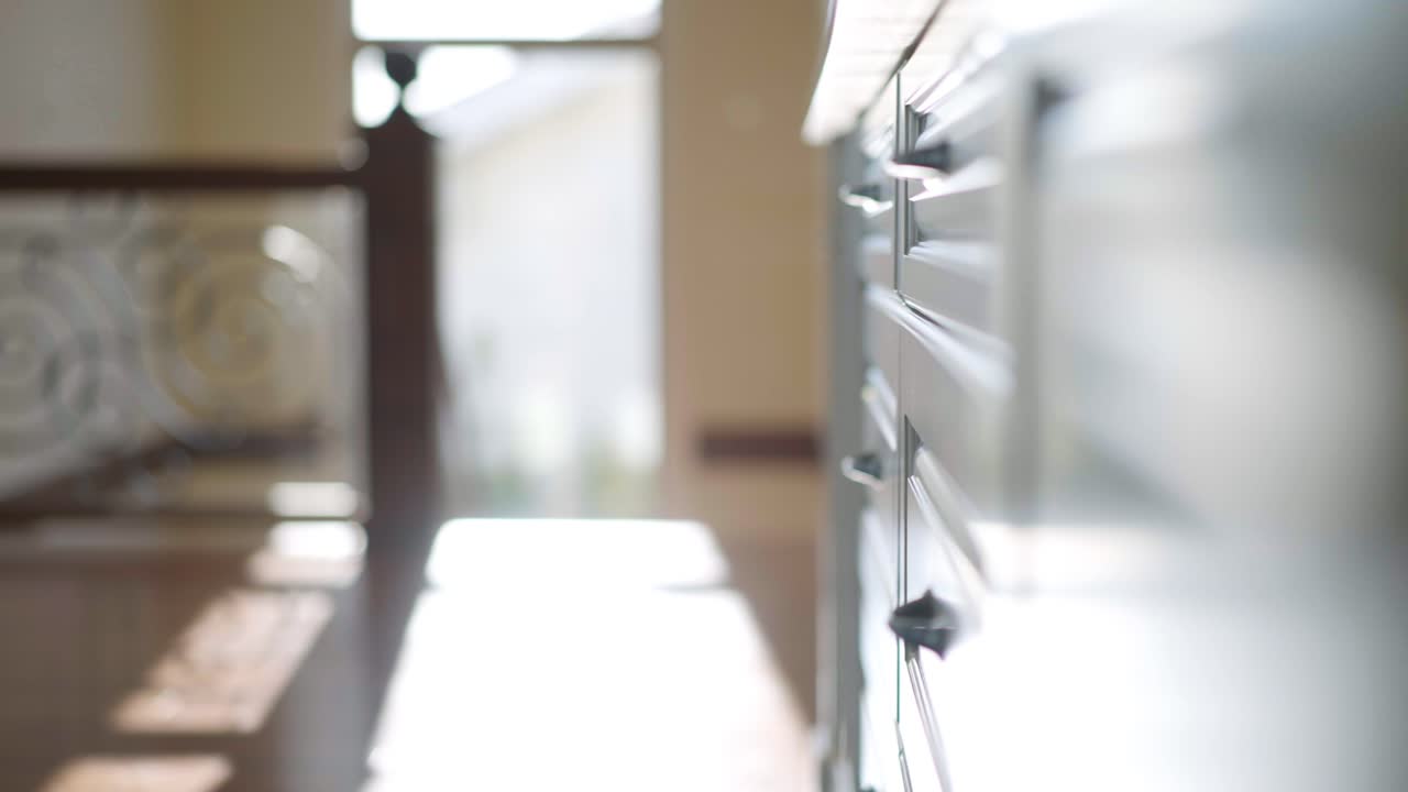A cinematic shot of a white cupboard in a luxury home shining under the sun