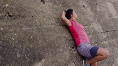 caucasian woman resting on a wall