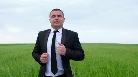 a young office worker runs in a field a young office worker runs in a field the man runs away from his problems the concept of freedom