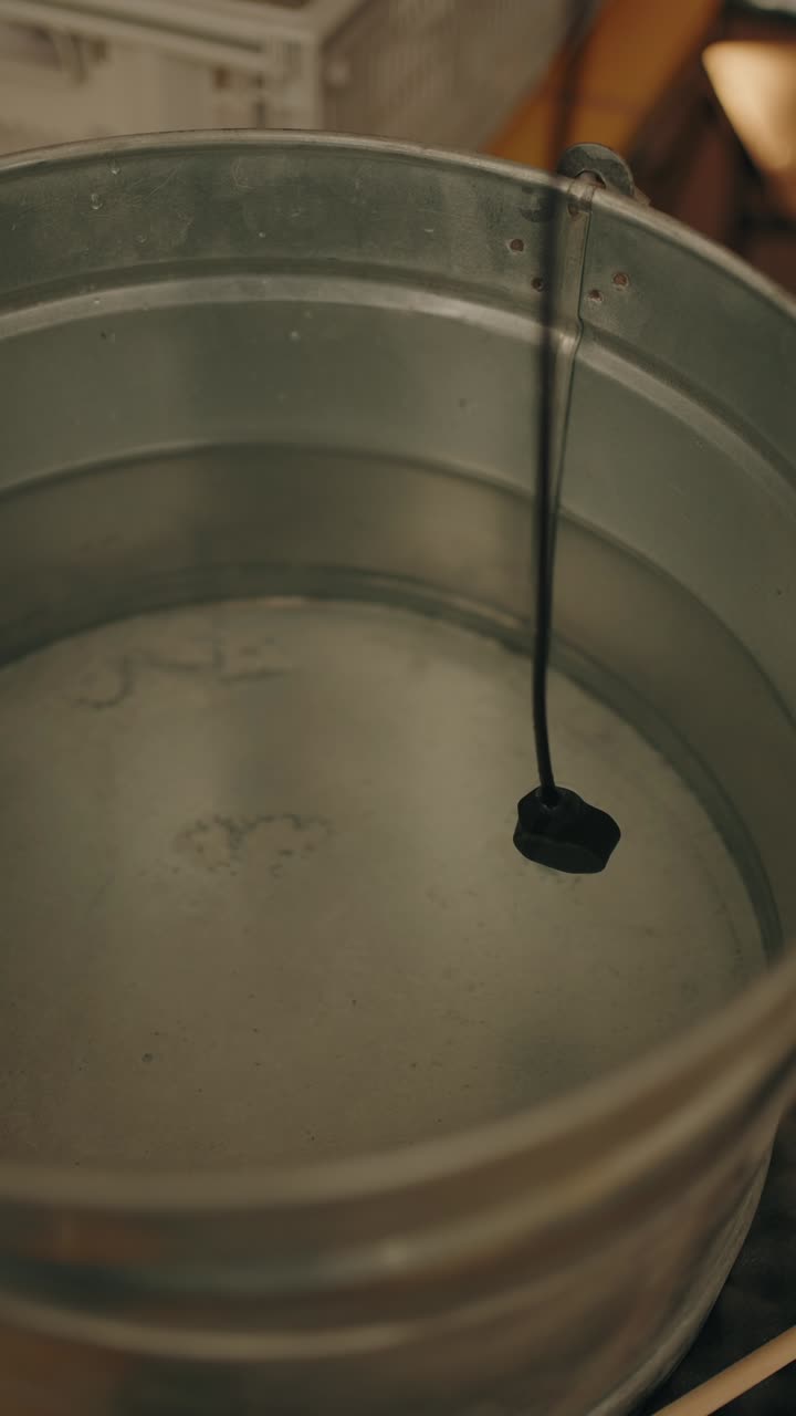 Vertical shot of hydrophone submerged in bucket for water sound recording