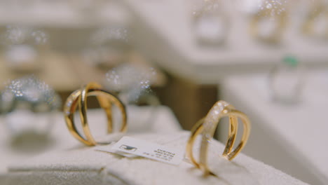 Gold Rings with Precious Pearls Rotating in a Shop Window