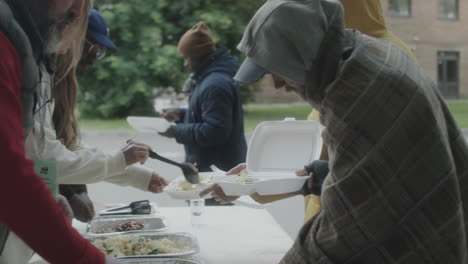 community volunteers distribute hot meals to homeless individuals