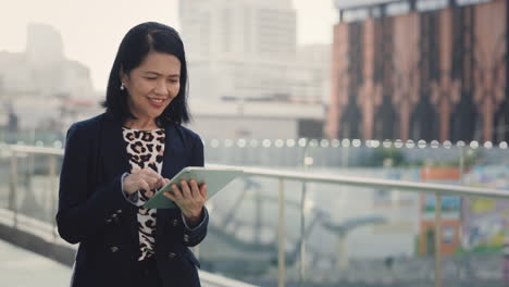 businesswoman using tablet in the city