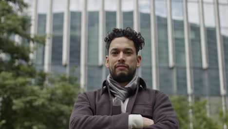 hispanic ethnicity male with cheerful and confident expression looking at camera in open air outdoors