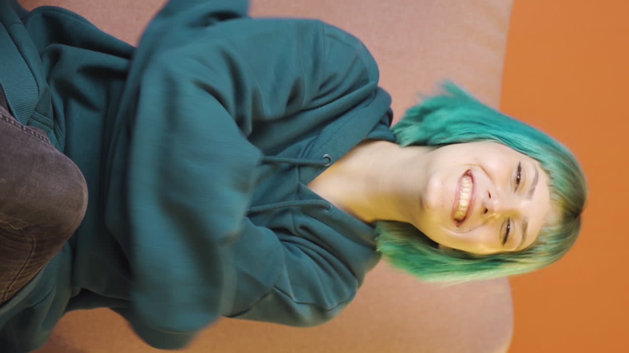 Vertical video of The young woman hugs the camera.