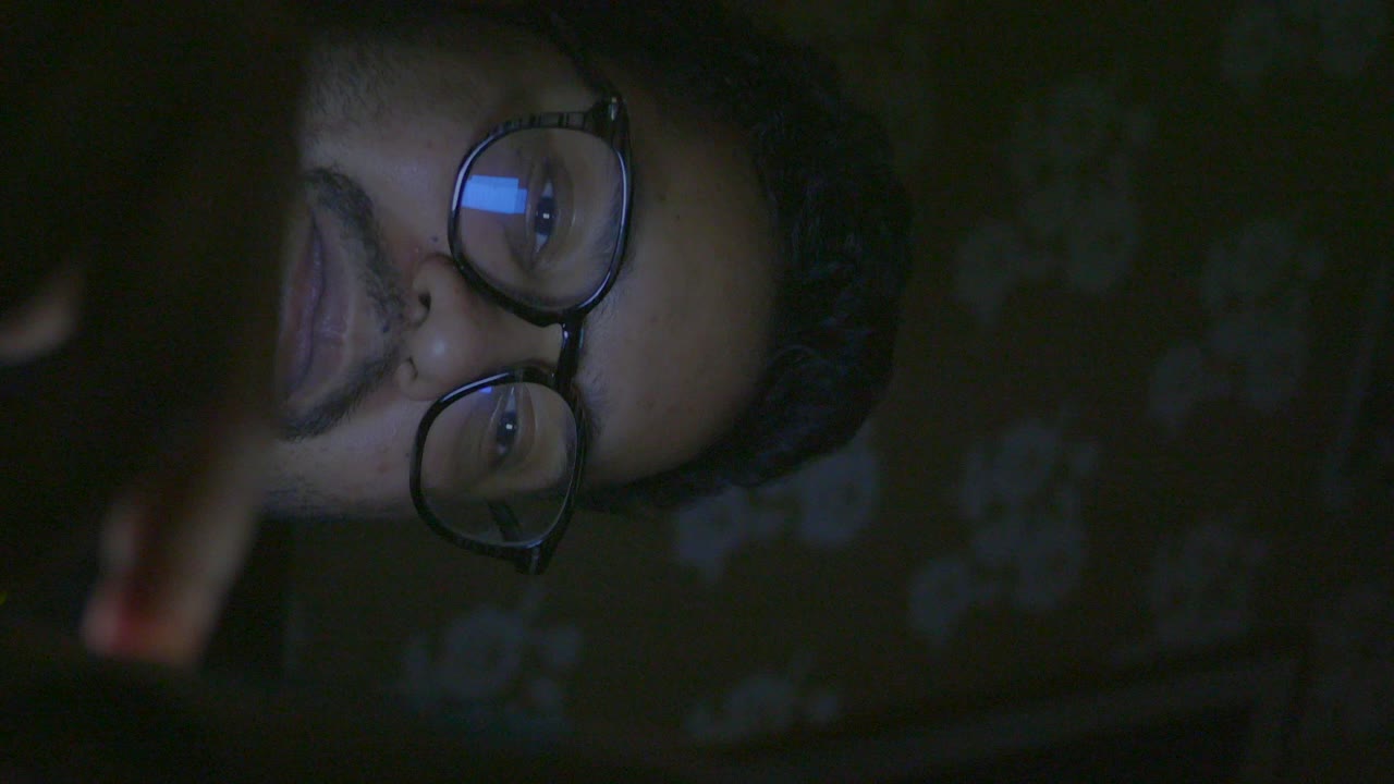 Man using a smartphone at night