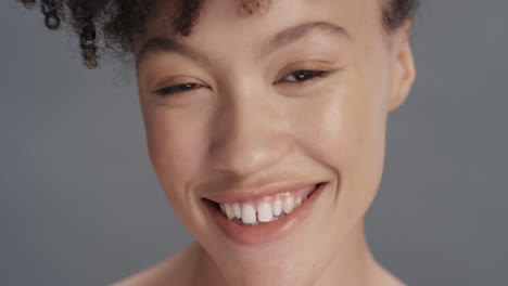 close up portrait beautiful mixed race woman touching soft skin with hand caressing smooth healthy complexion enjoying natural skincare gorgeous feminine beauty concept on grey background