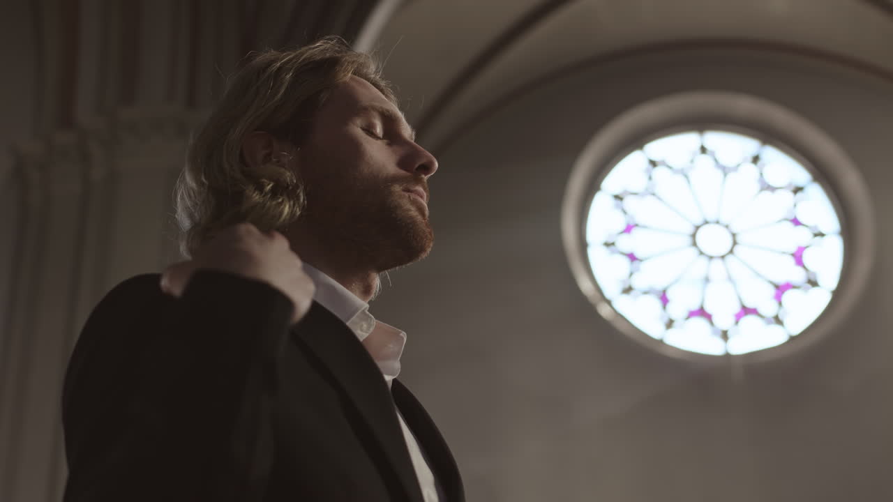 Young Caucasian Man Blessing Himself in Church