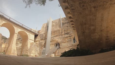 the bridge going over the ditch to the city gate of valletta, malta