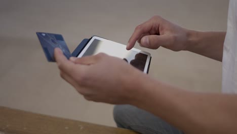 cropped shot of man making online purchases with tablet.