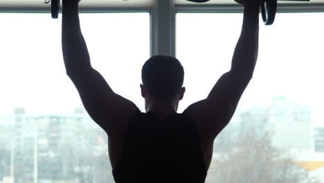 man lifting barbell overhead