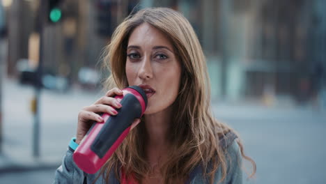 slow motion portrait of happy beautiful fitness woman drinking water
