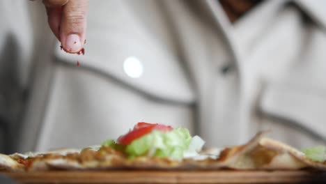 hand topping turkish pide with spices