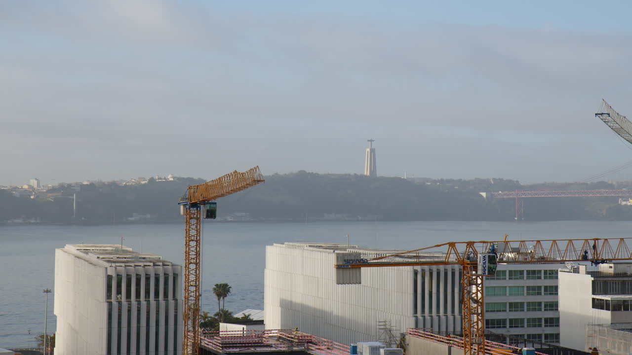 Buildings Along the Lisbon Port with a Distant View of Santu&aacute;rio de Cristo Rei and Ponte 25 de Abril Bridge