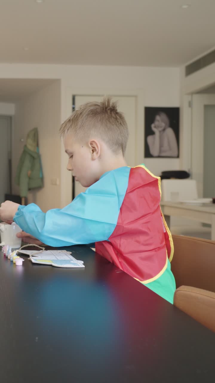 A young boy painting