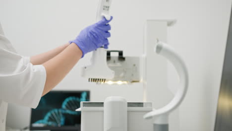 scientist using a micropipette in a laboratory