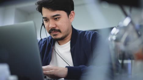 slow motion scene middle eastern adult call center employee man smiling with wear headset while talking with customer in operation office for contact us and telemarketing job concept