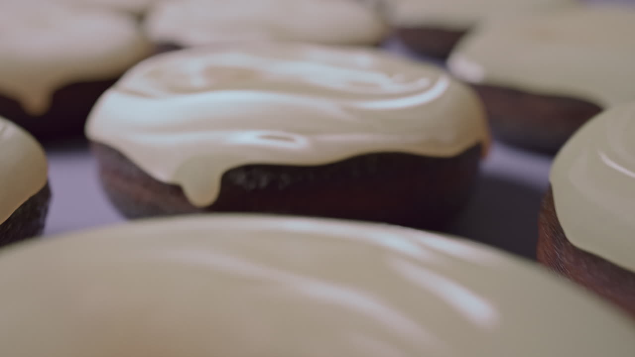 White glaze donuts on a light violet background