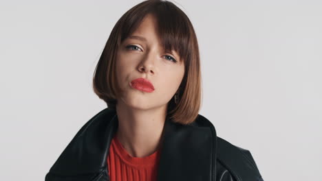 unhappy young woman in leather jacket posing