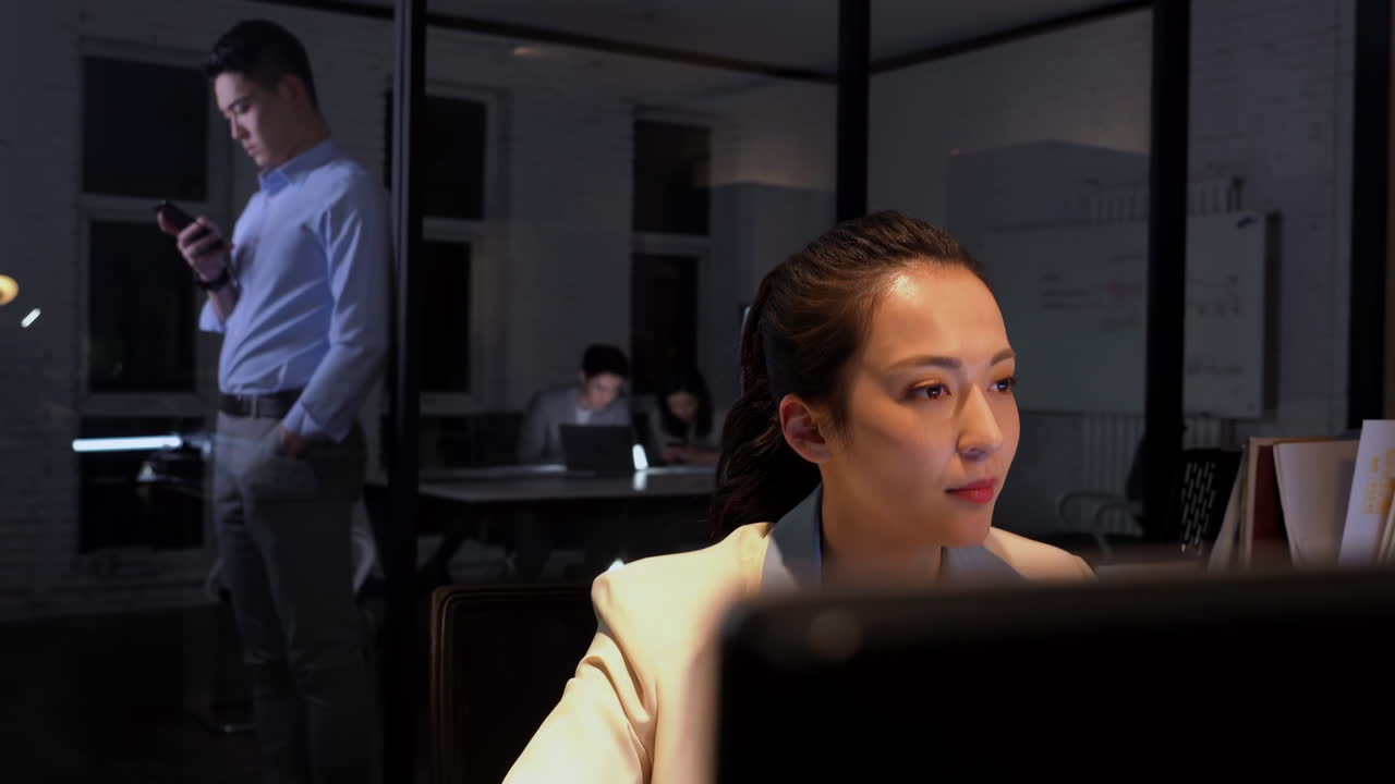 Meeting Strategy business team gathered around a table in a boardroom, discussing strategies for the upcoming quarter, using laptops and charts to analyze data and make decisions