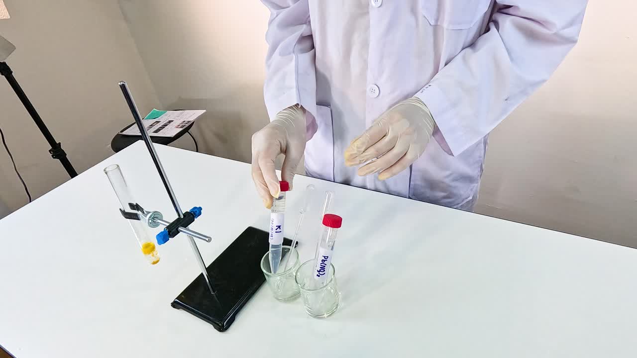 Scientist conducts a bromothymol blue experiment in a lab setting, showcasing chemical reactions and color changes