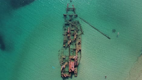 aerial shot by drone of a shipwrecked ship very close to a beach in epanomi,thessaloniki in greece 4k