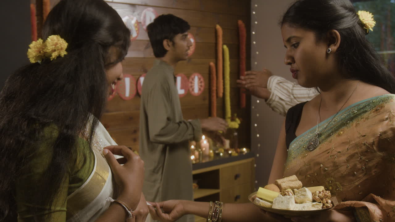 People celebrating an Indian festival with traditional clothing and food