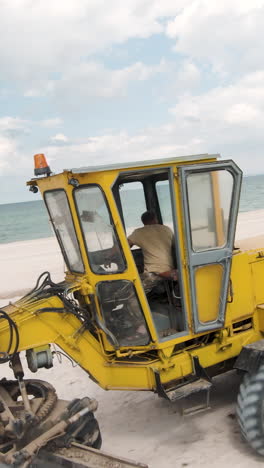 yellow construction equipment on beach