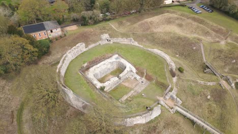 rotating drone view of bailey gate at castle acre priory ruins