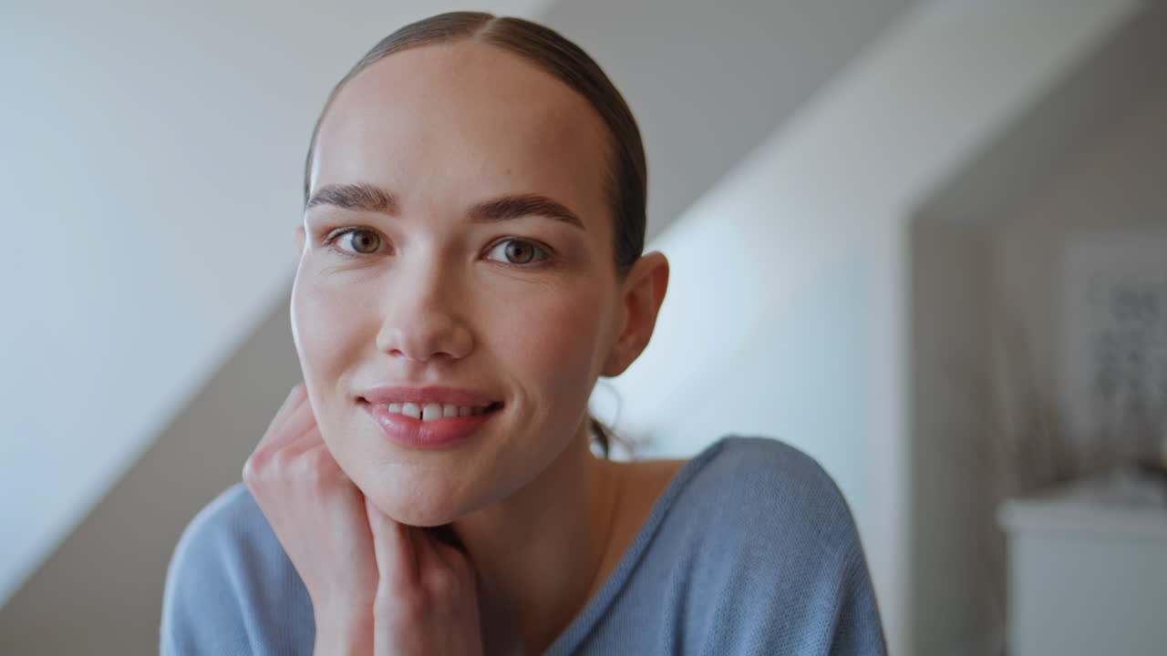 Carefree model looking camera relaxing at attic flat portrait. Dreamy woman