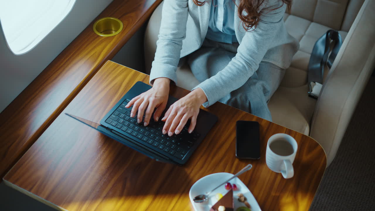 Businesswoman working on laptop in private jet