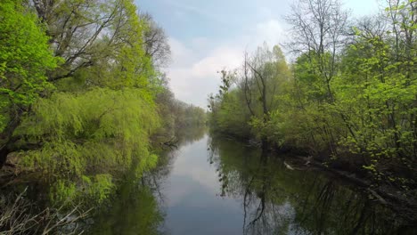 slow aerial dolly along the unteres heustadelwasser revealing the vienna cityscape