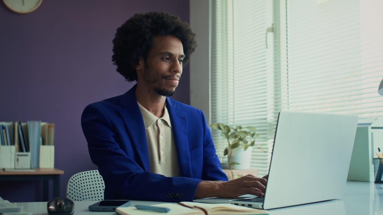 Portrait of African American Entrepreneur Working on Laptop at Office Desk