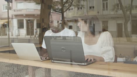 diverse coworkers using laptop and talking