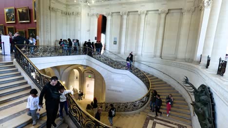 visitors ascend and descend a majestic staircase