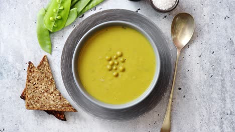 green pea cream soup in grey bowl