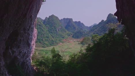 This-drone-footage-captures-a-breathtaking-journey-through-the-natural-archway-of-Angel-Eye-Mountain-in-Cao-Bang,-North-Vietnam