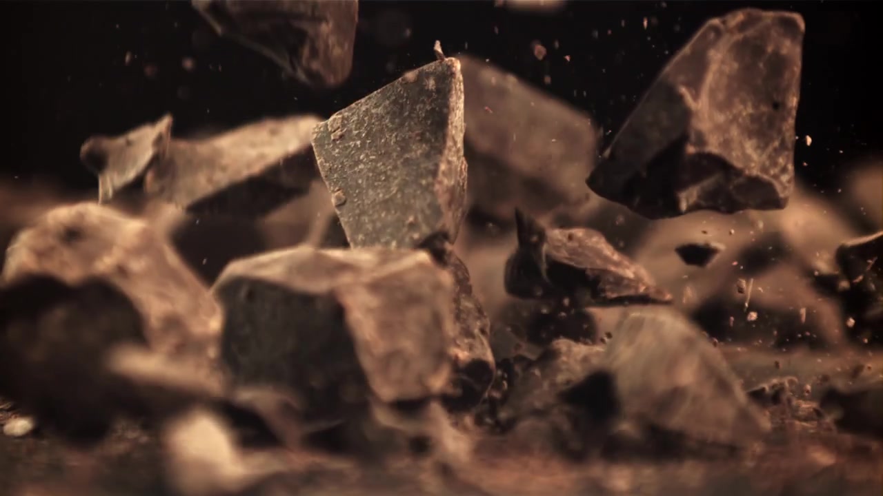 Slow Motion Chocolate Pieces Falling on a Dark Background