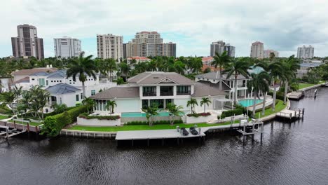 drone footage capturing luxurious waterfront mansions in a coastal south florida community