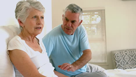 Worried-senior-couple-on-bed